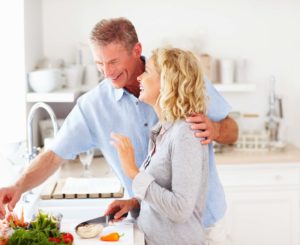 Portrait of a cute happy mature couple preparing food